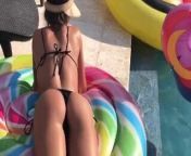 Izabel Goulart outdoors laying by a pool in a bikini from nude izabelle leite