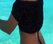 Annie-Marie jumping in the ocean in bikini bottoms from singer mari
