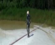 Super Hot Blond Girl In Black Latex Catsuit + High Heels And Sunglasses Bathes In The Mud - Mud Bath from lodo an